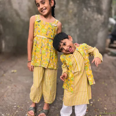 Sunshine in an outfit! This is one of my favorite sibling twinning sets, featuring a bright yellow floral print on a comfy kurta-bandi set for him and a matching top with striped pants for her. I design these so kids can run, jump, and give the best hugs without any fuss.