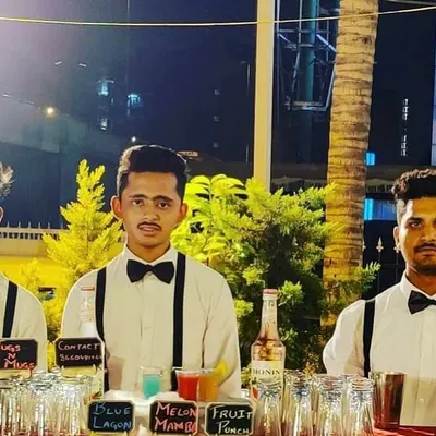 Our team of bartenders, looking sharp and ready to serve. Dressed in classic white shirts, bow ties, and suspenders, they bring a professional and stylish presence to any event.