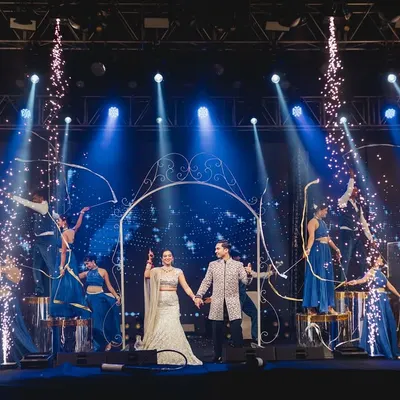 This couple wanted a grand entry that felt like a fairytale. I used a large archway prop and surrounded them with dancers as cold pyros lit up the stage, creating a truly magical start to their sangeet night.