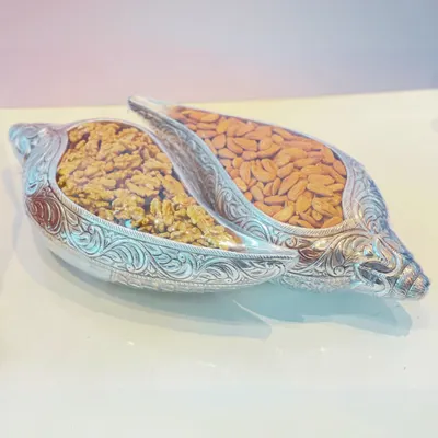 An elegant and traditional gift of health and prosperity. These ornate, shell-shaped silver containers are filled with premium walnuts and almonds.