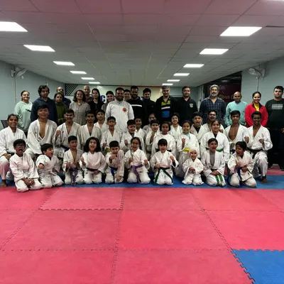 A group photo with students and their parents after a successful belt grading exam at our Noida branch. It is a proud day for the entire academy family.