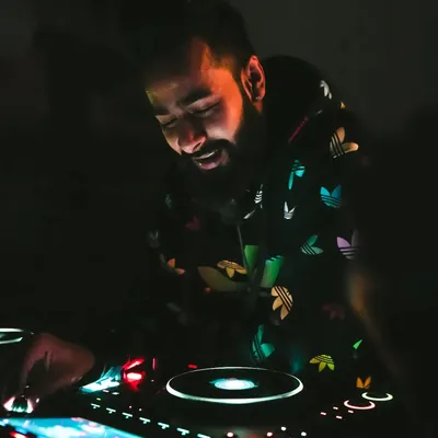 A quiet moment of focus before the beat drops. I use top of the line Pioneer CDJ equipment to ensure every transition is smooth and the sound quality is perfect for the venue.