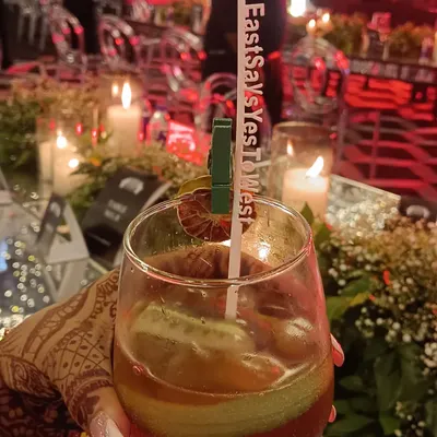 The little details matter. We offer personalized drink stirrers with your wedding hashtag, like this 'EastSaysYesToWest' stirrer, making every cocktail a part of your story.