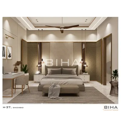 This master bedroom design features a rich interplay of textures, from the upholstered headboard to the contrasting wood-grain panels. Pendant lights hang low over the bedside tables, providing focused task lighting, while a dedicated study nook with a sleek desk offers a functional workspace within the tranquil environment.
