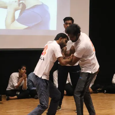 Demonstrating a wrist lock and control technique at a self-defence workshop for over 250 girls at GL Bajaj college.