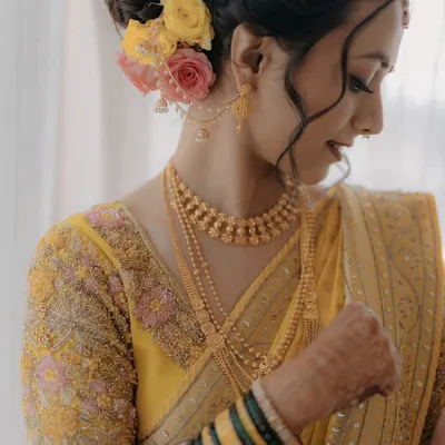 A close-up of my bride Krupali's wedding look, with a beautiful floral bun and traditional jewelry.