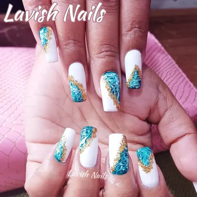 An intricate design inspired by Moroccan tiles, featuring a teal and white pattern with gold foil accents on square nails.