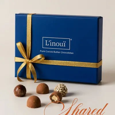Our classic royal blue gift box, tied with a gold ribbon, featuring an assortment of pure cocoa butter chocolates. It's the perfect way to share delight and make amends for all the snacks you've stolen from your sibling this Rakhi.