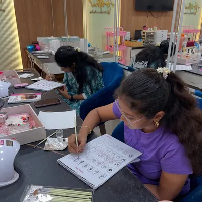 A glimpse into our acrylic and drill session. Students start by practicing designs on paper to understand the fundamentals of nail art.