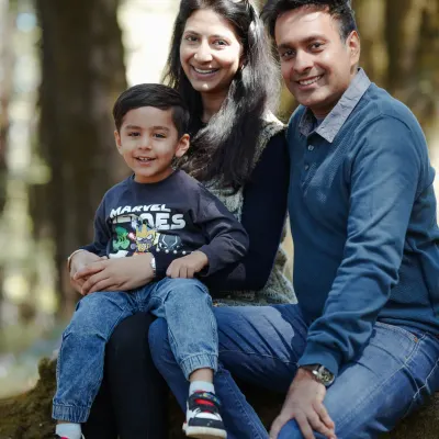 A happy family of three enjoying the fresh mountain air. Outdoor sessions allow for natural, relaxed portraits like this one, where the family's connection feels effortless and real.