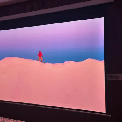 A giant screen can transform your bedroom into a private movie theater. This shot shows the incredible scale and vibrant color of a projector screen setup, perfect for an ultimate home cinema experience.