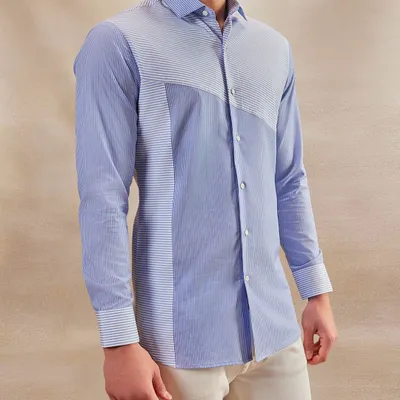 From boardrooms to soirées, this shirt speaks pure class. The unique paneling of striped fabrics creates a modern, sophisticated look that is both versatile and memorable.