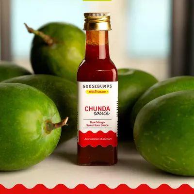 Our newly launched Chunda Sauce, surrounded by the fresh Ladwa mangoes it's made from. This sweet, tangy, and lightly spiced sauce is an evolution of the traditional Gujarati pickle.