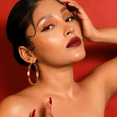 Channeling old Hollywood glamour with a modern twist. This look is all about the classic, bold red lip, flawless skin, and the iconic finger waves. It's a timeless statement of confidence.