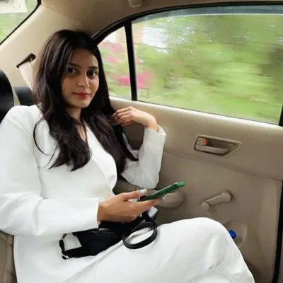 In a white suit, on the move between appointments. My style is an extension of my personality: sharp, modern, and always ready for business.