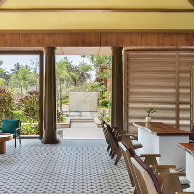 The view from our lobby showcases the seamless blend of indoor and outdoor spaces. The architecture is designed to frame the natural beauty of our gardens and the hills beyond.