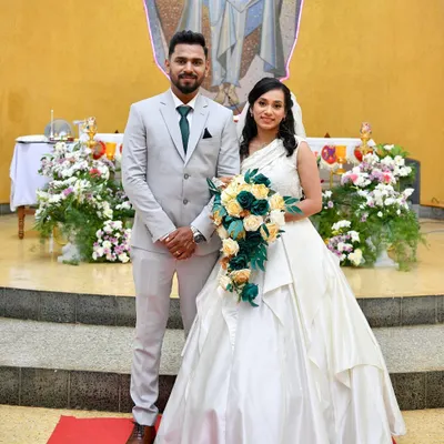 A beautiful Christian bride and groom. I designed and created this elegant one-shoulder white wedding gown for her special day.