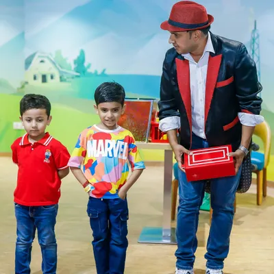 Our magician engaging young guests with an interactive trick. A magic show is a fantastic add-on to keep partygoers mesmerized.