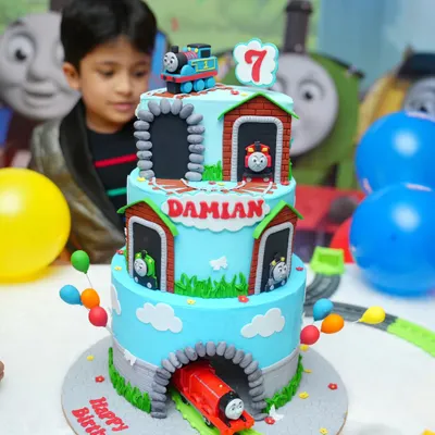 All aboard for Damian's 7th birthday! This three-tier Thomas & Friends cake was a true showstopper, featuring a rotating train centerpiece and edible models of all the favorite characters. The birthday boy's reaction says it all!