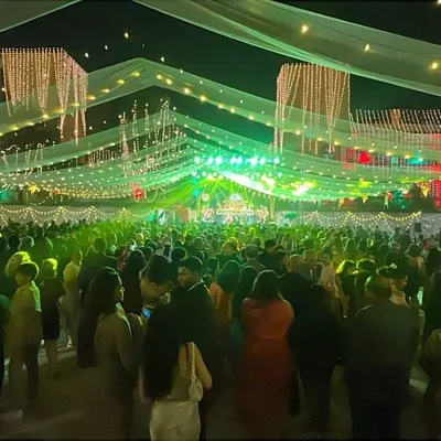 A wide-angle view of a massive crowd under festive lights. This is the kind of atmosphere we create, turning any venue into a vibrant party.