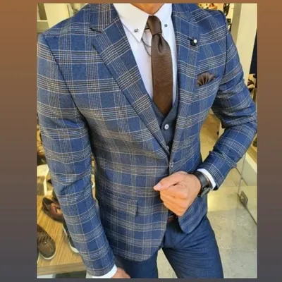 This three piece suit in a blue and tan check pattern is a great example of a modern business look. The waistcoat adds a layer of formality, while the pattern provides a touch of personal style.