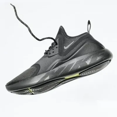 A sleek, all-black sneaker captured mid-air with its lace flying, creating a sense of motion and energy. This dynamic shot is perfect for performance footwear.