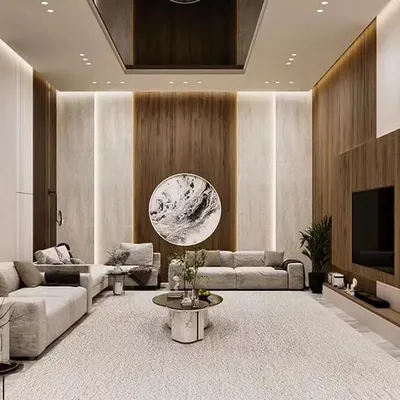 This expansive living room showcases our ability to handle large-scale projects, featuring a neutral color palette, wood and marble paneling, and a layout designed for both grand entertaining and quiet family evenings.