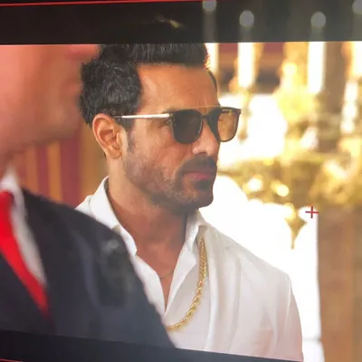 A monitor shot of John Abraham during a shoot. I styled him in this crisp white shirt, gold chain, and sunglasses to create a suave and powerful character look.