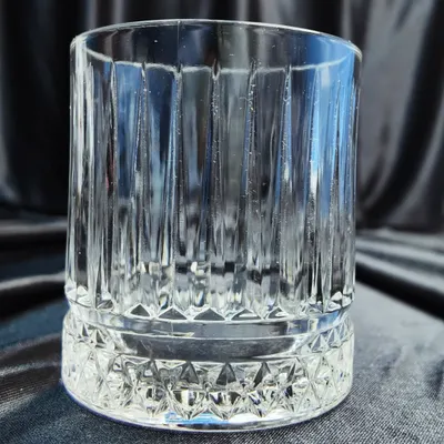 This is our crystal-cut rocks glass, ideal for serving spirits neat or on the rocks. Its weighted base and intricate design add a touch of class to any whisky or bourbon drink.