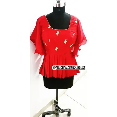 A bright red peplum top with flowy bell sleeves. I added subtle floral embroidery to give this modern silhouette a touch of traditional craftsmanship.