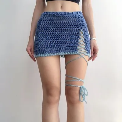 This blue mesh crochet skirt shows how my designs look when worn. The fit is comfortable and the leg wrap detail adds a unique touch. It’s a great example of a custom two-tone piece, with a light blue border.