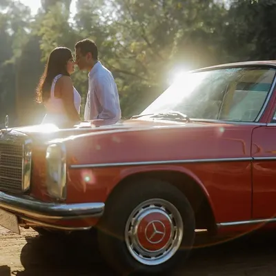 This shot has that 90s cinematic vibe I absolutely love. We used a vintage red Mercedes for this couple's shoot near Delhi, and the golden hour sun flare created the perfect romantic, film-like atmosphere for their kiss.