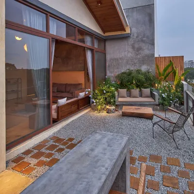 The penthouse terrace is designed as an outdoor living room, seamlessly extending the interior space. We used gravel, wood, and a custom concrete bench to create a rustic, tranquil escape with views of the city.