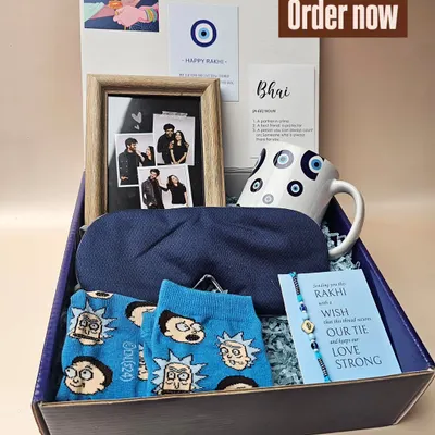 For the brother who deserves more than just sweets. This evil-eye themed hamper includes a personalized photo frame, a quirky mug, fun socks, and a comfy eye mask, all packed in a stylish gift box.