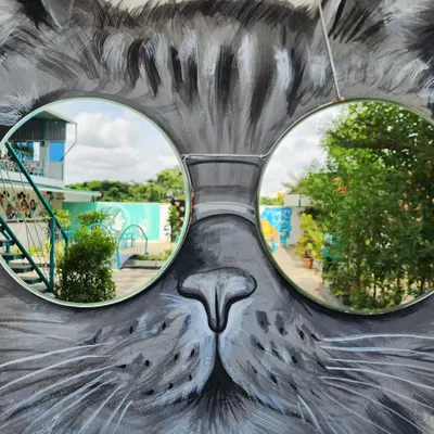 Putting reflective mirror shades on a mural never looked this cool. We created this cat mural with integrated mirrors for sunglasses, allowing people to see their reflection in the artwork.