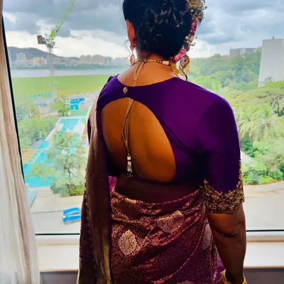 A soft glam look with a traditional braided bun for this beautiful client. This back shot shows the intricate hairstyle and how it complements the stunning purple saree.