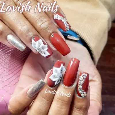 A luxurious set of red and silver nails, featuring 3D sculpted white flowers, intricate rhinestone patterns, and a full-coverage silver glitter accent nail. This is a perfect example of a high-drama, special occasion manicure.