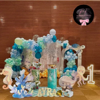 A beautiful 'One-der the Sea' setup for Ayra's first birthday. The scene includes a full balloon backdrop, custom sea creature cutouts, and personalized marquee letters.