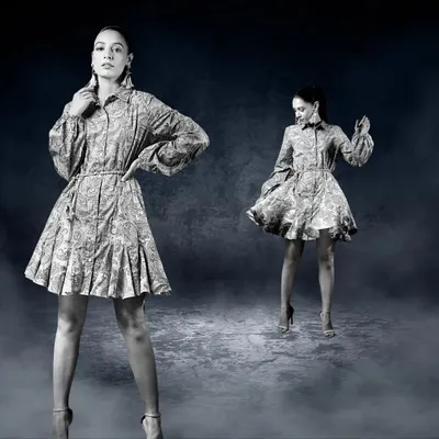 A creative, composite image showing two versions of a model in a patterned dress against a moody, textured background. This artistic approach creates a dynamic and visually interesting fashion photograph.