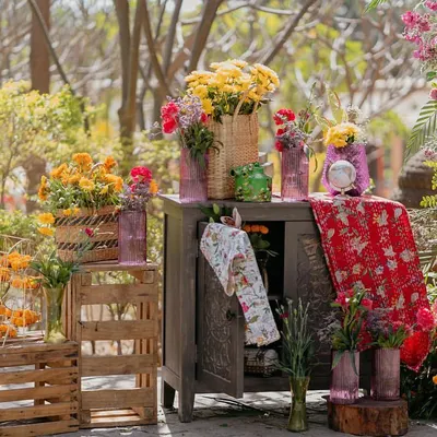 The entrance to our 'Rajasthani Folklore' Mehendi. We created a contemporary mela vibe with an explosion of colorful florals, rustic crates, and traditional fabrics to welcome guests into a world of fun.
