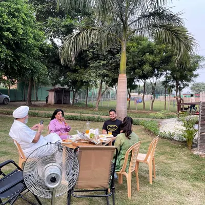 Our spacious lawns are perfect for a family picnic. Here's the Bakshi family enjoying a peaceful meal together surrounded by nature.