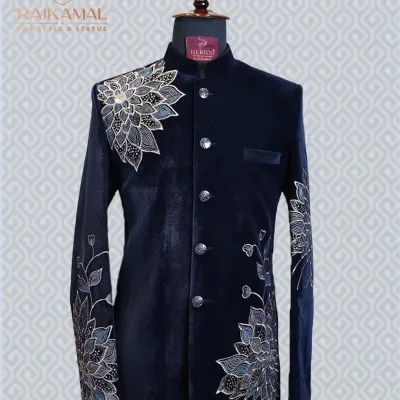 This navy blue velvet Jodhpuri suit is the epitome of class. The detailed floral embroidery on the shoulder and sleeve adds a touch of artistry to its regal design.