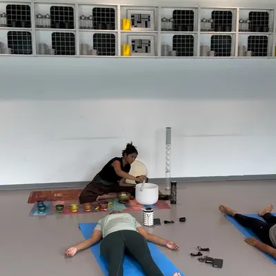 During a personalized session, a client rests in Savasana while I play the crystal singing bowl. The focused attention in a private setting allows for a much deeper and more targeted healing experience.