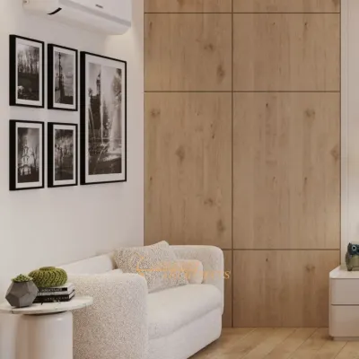 A cozy reading nook within the bedroom, featuring a plush bouclé sofa against a warm wood-paneled wall. This corner is a perfect example of how we create functional, intimate zones within a larger space.