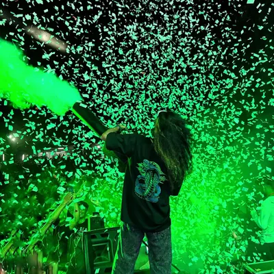 Blasting the crowd with green light and confetti. The use of color and effects is key to creating the high-energy atmosphere of my shows.