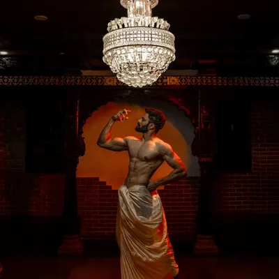 A powerful and artistic shot featuring a male model in a perfectly draped dhoti. This showcases a modern, royal look for grooms.