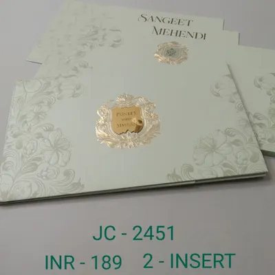 This elegant invitation uses a simple color palette of off-white and gold. The design features a classic crest and subtle floral embossing for a touch of texture.