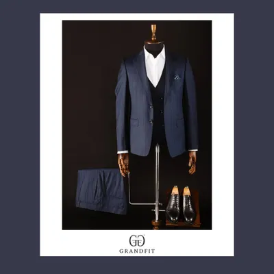 A classic navy pinstripe three-piece suit, the epitome of corporate elegance. The waistcoat adds a formal touch, while the pinstripes convey a sense of tradition and authority.