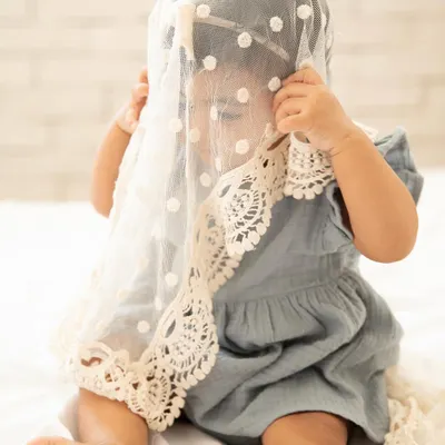 A playful game of peek-a-boo during a sitter session. I love capturing these spontaneous, joyful moments as babies explore different textures and props.