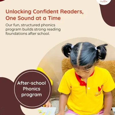 A young girl in pigtails concentrates on a book, showcasing the focus our fun, structured phonics program inspires. We build strong reading foundations one sound at a time.